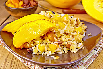 Image showing Pilaf fruit with pumpkin in brown plate on board