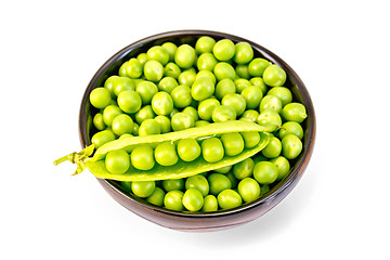 Image showing Green peas in brown bowl with pod