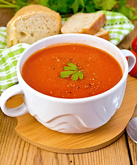 Image showing Soup tomato with pepper in bowl on board