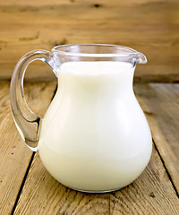 Image showing Milk in glass jug on board