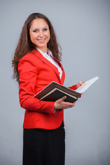 Image showing Young attractive girl in red with folders