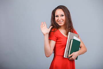 Image showing Young attractive girl in red with folders