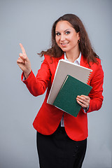 Image showing Young attractive girl in red with folders