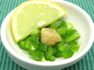 Image showing Dices of green  pepper with sugar and lemon in a little bowl of chinaware