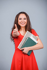 Image showing Young attractive girl in red with folders