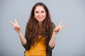 Image showing Woman shows symbol of victory