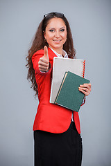 Image showing Young attractive girl in red with folders