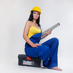 Image showing working girl in yellow helmet