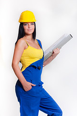 Image showing working girl in yellow helmet