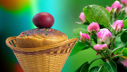 Image showing Easter cakes and red Easter egg beside a blossoming Apple tree.