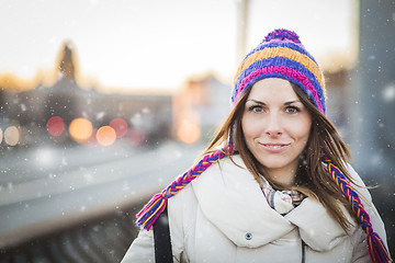 Image showing Positive girl with colorfull hat in winter city