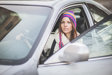 Image showing Young woman in a rental car