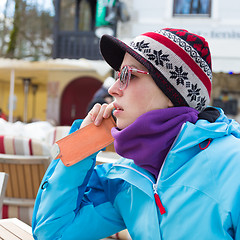 Image showing Woman in ski resort using smartphone.