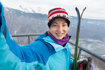 Image showing Female skier taking selfie.