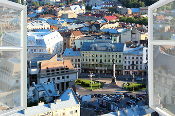 Image showing opened window to the roofs of city