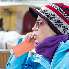 Image showing Woman in ski resort using smartphone.