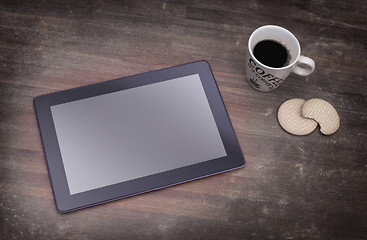 Image showing Tablet touch computer gadget on wooden table