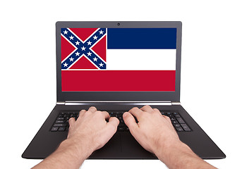 Image showing Hands working on laptop, Mississippi