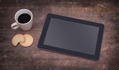 Image showing Tablet touch computer gadget on wooden table