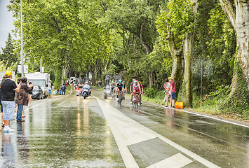 Image showing Group of Cyclists in a Rainy Day