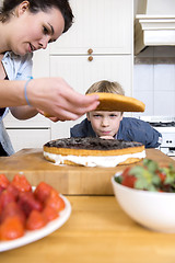 Image showing Boy Looking At woman Preparing Cake