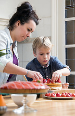 Image showing Mother And Son Preparing Cake In Kitchen