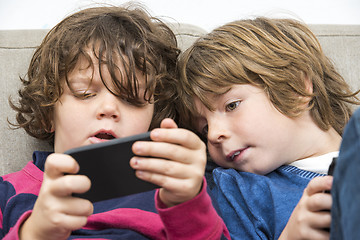 Image showing Brother and sister Using Smart Phone On Sofa