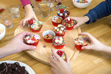 Image showing Kids Picking Cupcakes At Table