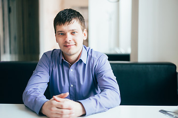 Image showing Handsome Thinking Man In Shirt Sitting In Cafe