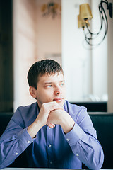 Image showing Handsome Thinking Man In Shirt Sitting In Cafe