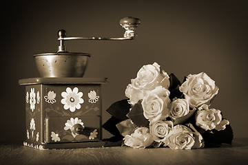 Image showing Blue coffee grinder and roses