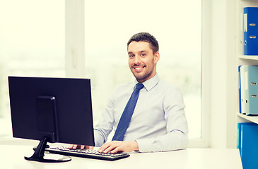 Image showing smiling businessman or student with computer