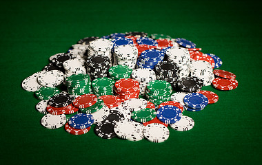 Image showing close up of casino chips on green table surface