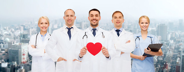 Image showing group of smiling doctors with red heart shape