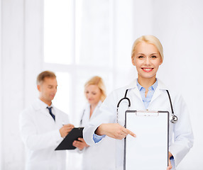 Image showing smiling female doctor with clipboard