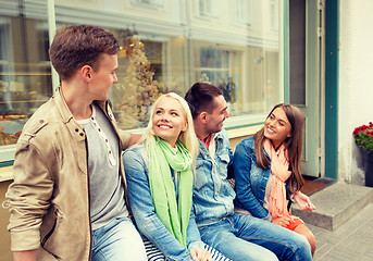 Image showing group of smiling friends walking in the city