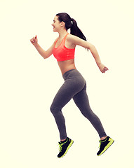 Image showing sporty woman running or jumping