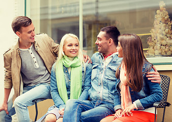 Image showing group of smiling friends walking in the city