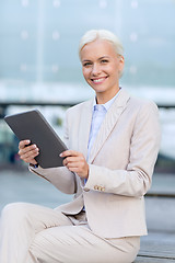 Image showing smiling businesswoman with tablet pc outdoors