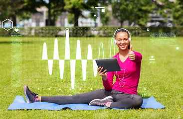 Image showing smiling woman with tablet pc outdoors