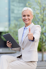 Image showing smiling businesswoman with tablet pc outdoors