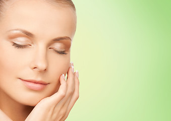 Image showing beautiful young woman touching her face