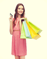 Image showing smiling woman in dress with many shopping bags