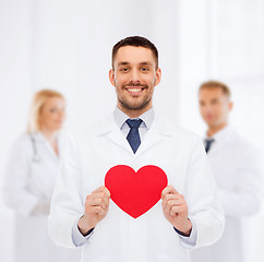 Image showing smiling male doctor with red heart