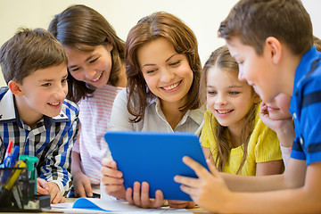 Image showing group of kids with teacher and tablet pc at school