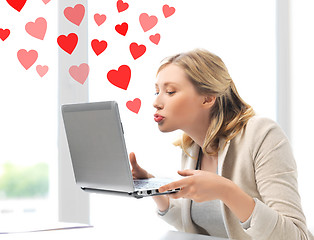 Image showing woman sending kisses with laptop computer