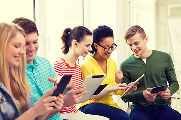 Image showing smiling students with tablet pc at school