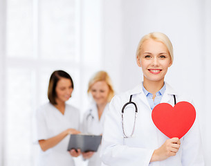 Image showing smiling female doctor with heart and stethoscope