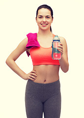 Image showing sporty woman with towel and water bottle