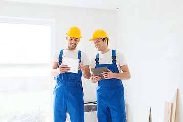 Image showing builders with tablet pc and equipment indoors